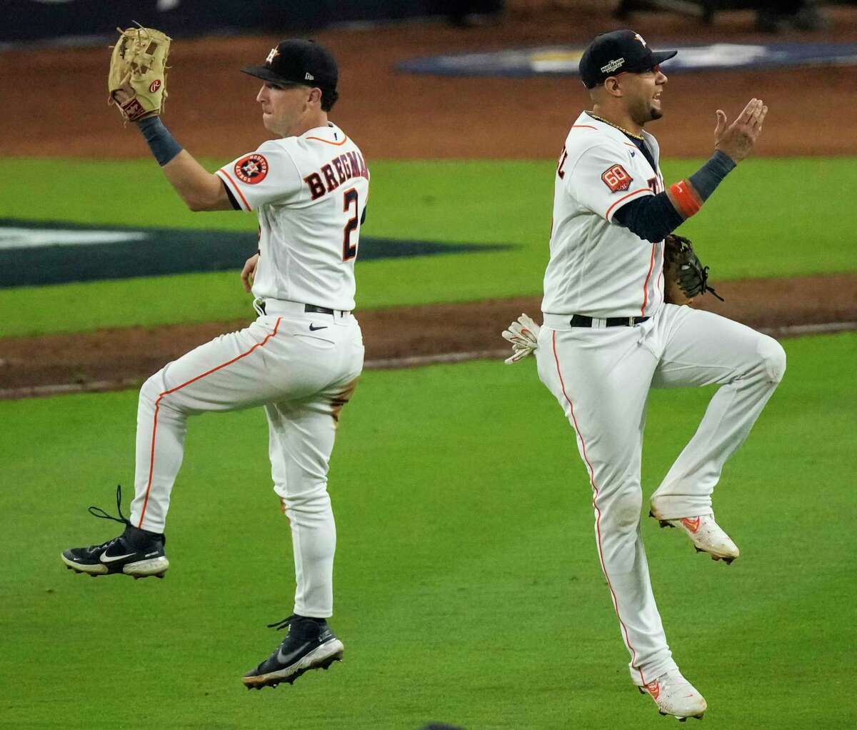 Houston Astros first baseman Yuli Gurriel (10) gives third baseman Alex Bregman (2) a high-five after defeating the New York Yankees 4-2 to win Game 1 of the American League Championship Series at Minute Maid Park on Wednesday, Oct. 19, 2022, in Houston.