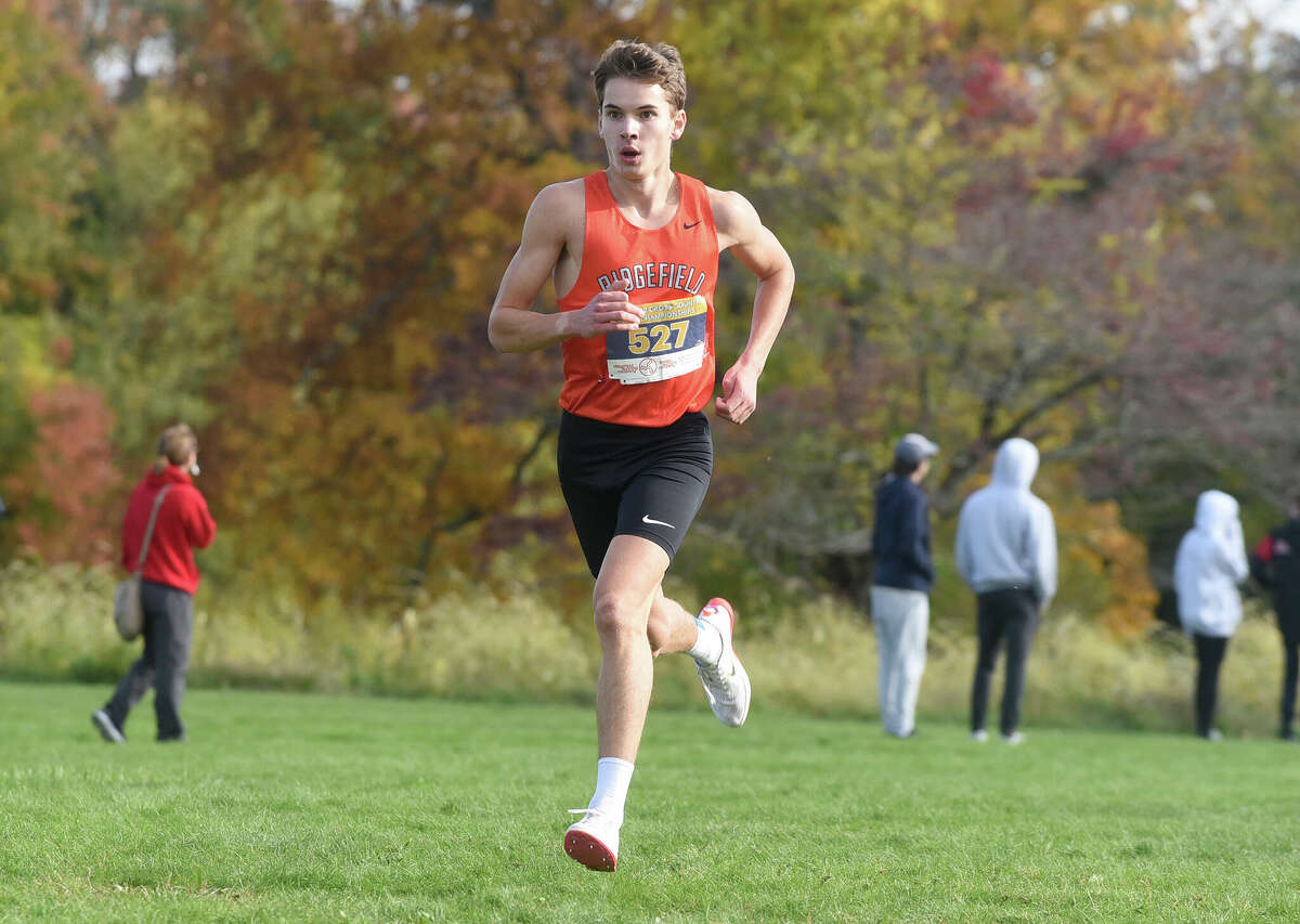 Ridgefield's Steven Hergenrother runs to a first-place finishat the FCIAC boys cross country championship at Waveny Park in New Canaan on Wednesday, Oct. 19, 2022.