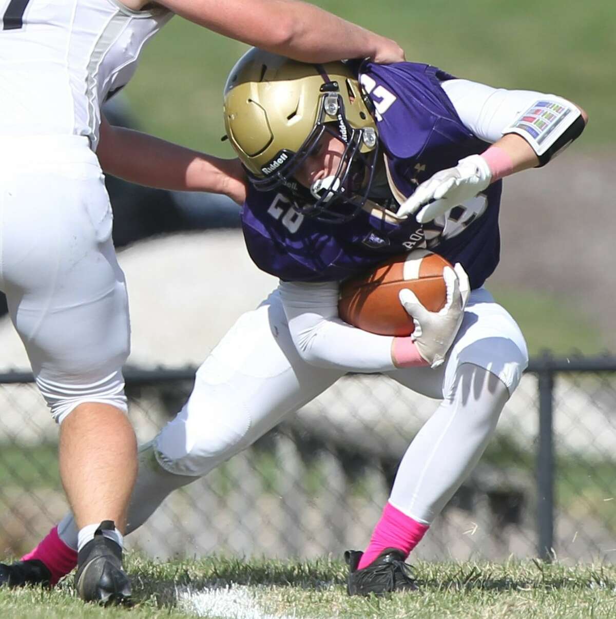 Routt's Dax Baptist pulls away from a tackler during a football game against West Central at the old MacMurray College field in Jacksonville last Saturday.