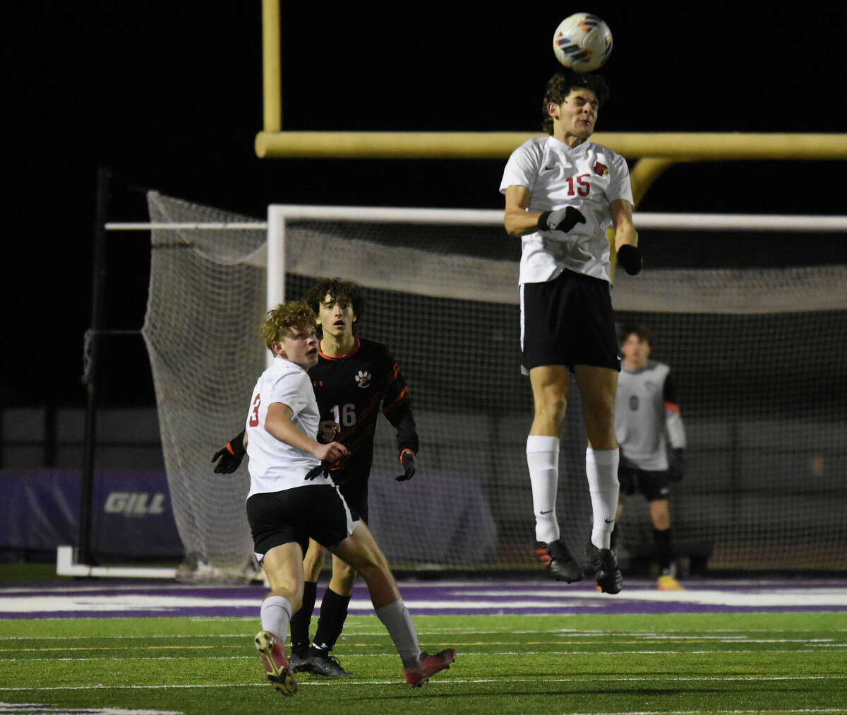 Alton's Ashton Schepers goes high for a ball during the Class 3A Collinsville Regional semifinals on Wednesday at Kahok Stadium in Collinsville.