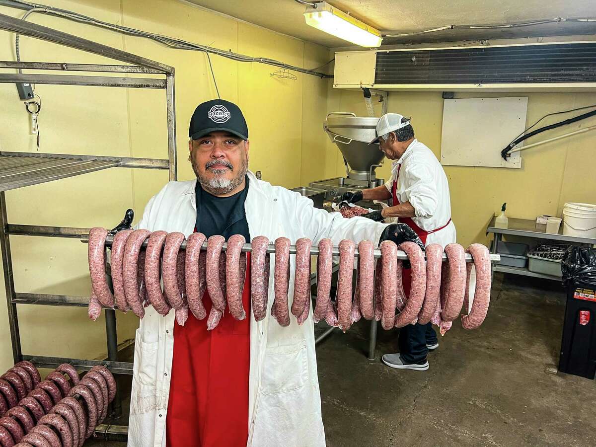 Sammy Palomarez (front), Sam Palomarez (back) with custom-made venison sausage ready for the smoker at Dozier's BBQ, Fulshear