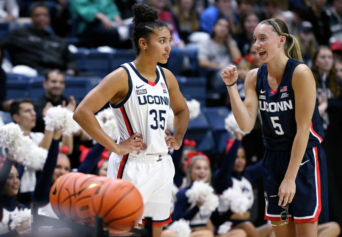 Connecticut's Paige Bookers (right) slammed into the team as Fudd competed in the 3-point contest at the school's men's and women's NCAA college basketball team's first night event Friday, Oct. 14, 2022 in Storrs, Connecticut. Talk to your mate, Azi Fad (left).  (AP Photo/Jessica Hill)