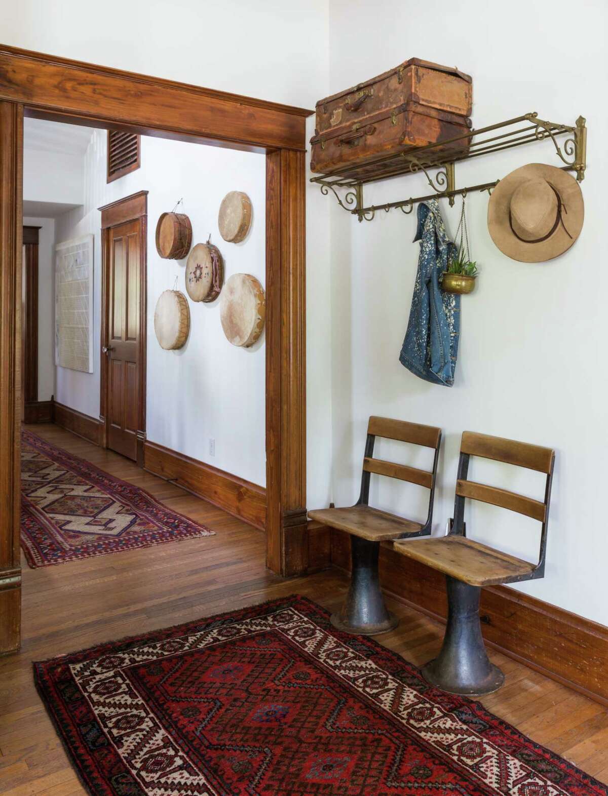 For the foyer in a client's Heights home, Houston interior designer Jana Erwin of Nest Design Group found vintage stadium chairs at The Compound, a vintage luggage rack at McClaren's Antiques and vintage suitcases at the Big Red Barn.