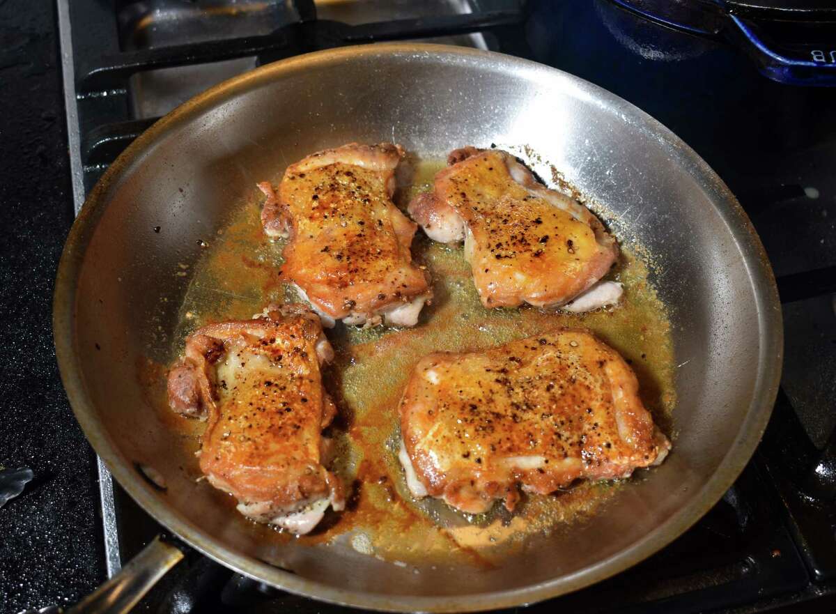 Weighting deboned chicken thighs in your frying pan will produce extra-crispy skin.