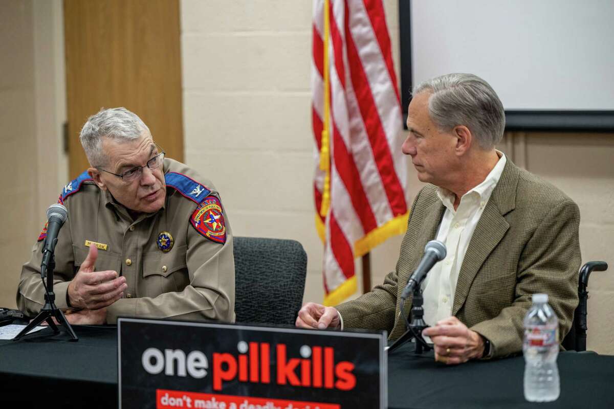 Gov. Greg Abbott speaks with DPS Director Steve McCraw on Oct. 17 in Beaumont about the health care issues caused by fentanyl. A reader asks why, in his years in office, Abbott has let health care slide in Texas.