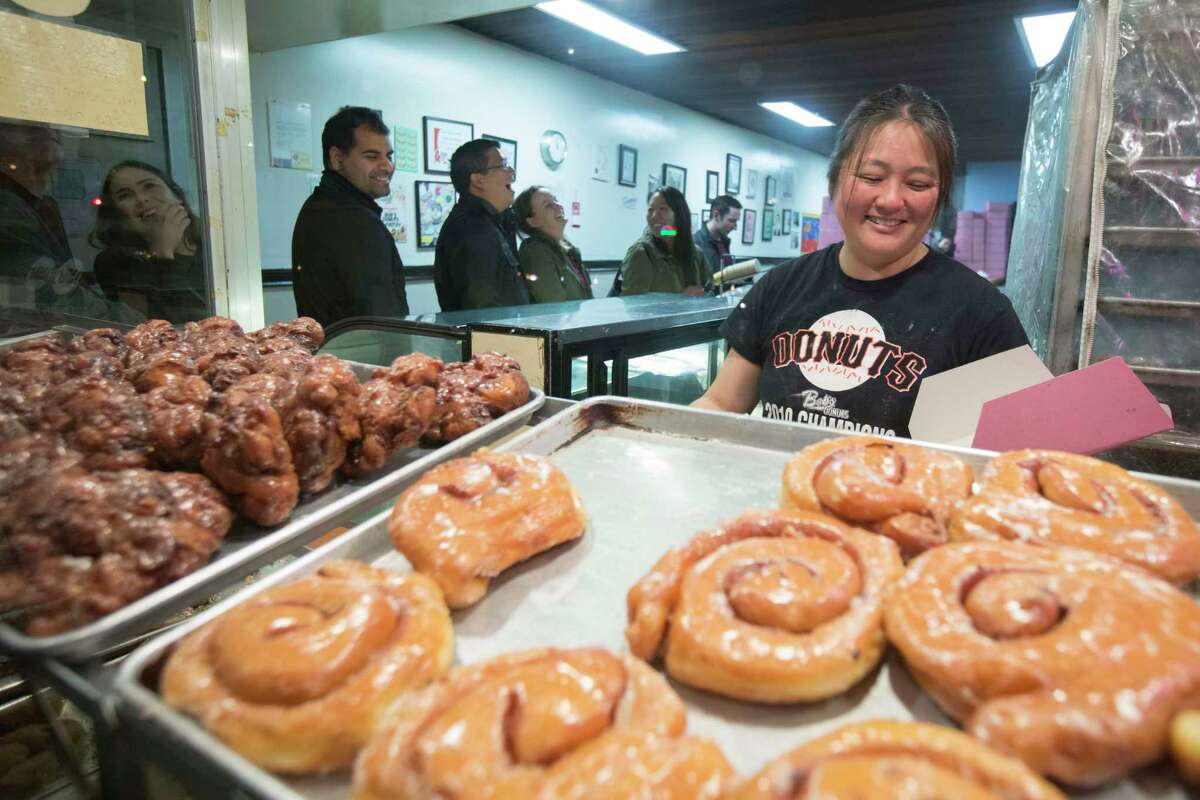 Aya Ahn, the owner of Bob’s Donut & Pastry Shop in S.F., boxes doughnuts for a customer in 2016.