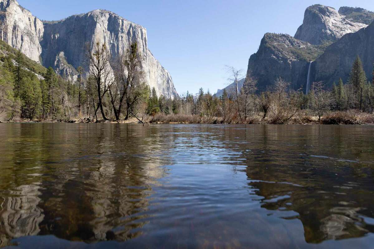 El Capitan and other peaks are seen reflected in the Merced River at Yosemite National Park in March. Research published this week shines light on the age of Yosemite Valley.