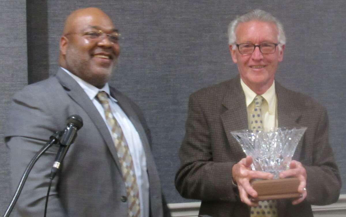 Alton Godfrey Rotary Club President Antione Williams, left, presents the Service Above Self award to Dick Alford on Thursday night. It is only the ninth time the award has been presented.