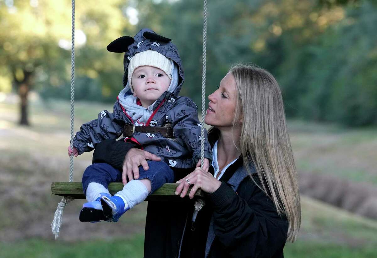 Kinsey Barnett, occupational therapist, works with Cyrus Mood on a swing during his therapeutic horseback session at Special CHEERS, 12570 Clay Rd., Thursday, Oct. 20, 2022, in Houston.