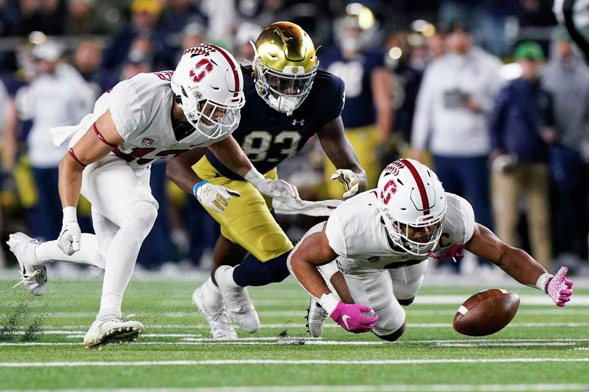 Stanford safety Jonathan McGill, right, recovers a fumble past cornerback Ethan Bonner, left, and Notre Dame wide receiver Jayden Thomas during the second half of an NCAA college football game in South Bend, Ind., Saturday, Oct. 15, 2022. Stanford won 16-14. (AP Photo/Nam Y. Huh)