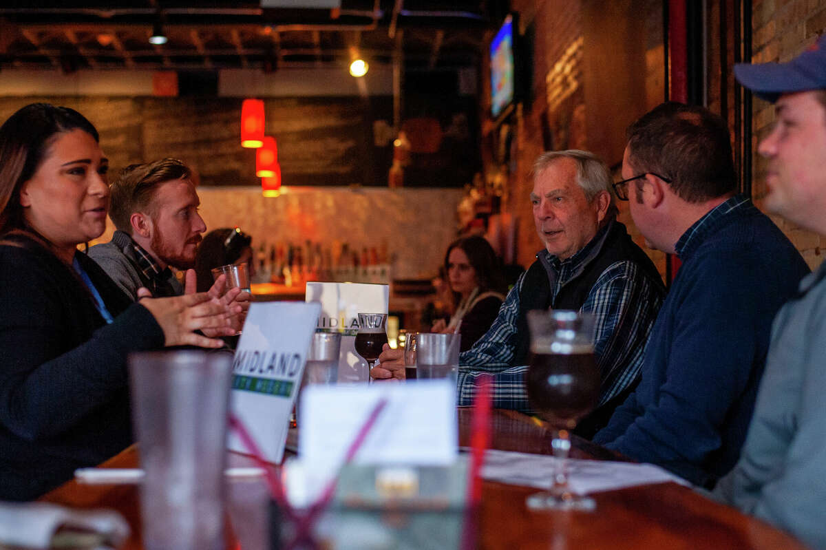 Midland resident Karl Kamena (center) chats with city officials about the city's master planning process on Oct. 19, 2022 at Witchcraft Taproom.