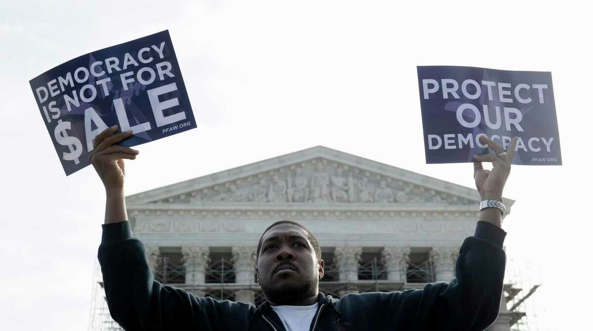 Cornell Woolridge of Windsor Mill, Md., takes part in a demonstration outside the Supreme Court in Washington as the court heard arguments on campaign finance in 2013. (AP Photo/Susan Walsh, File)