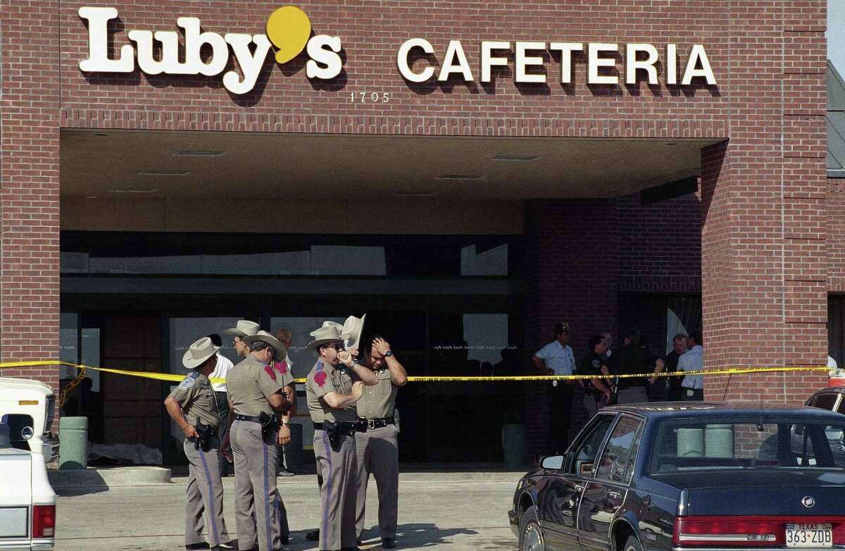 Police officers gather outside Luby’s Cafeteria in Killeen, where a gunman killed 23 people including himself in October 1991.