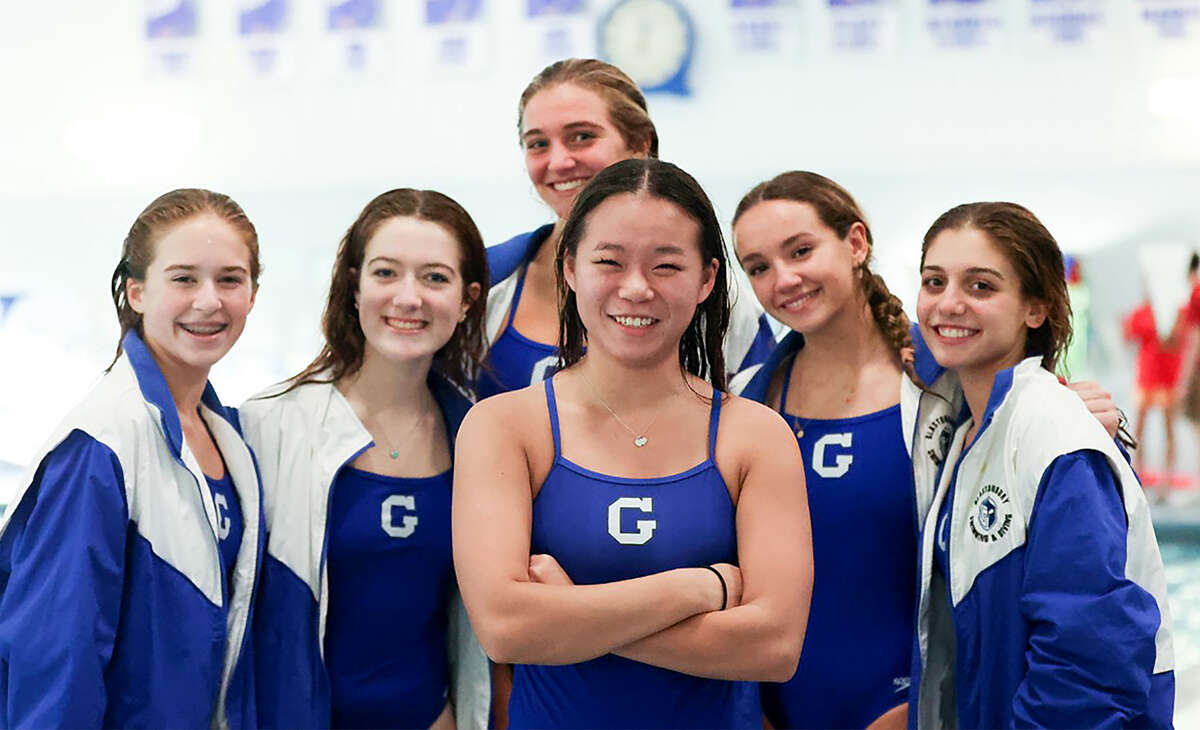 Glastonbury diver Jade Casey with some of her teammates on the Guardians' girls swimming and diving team.