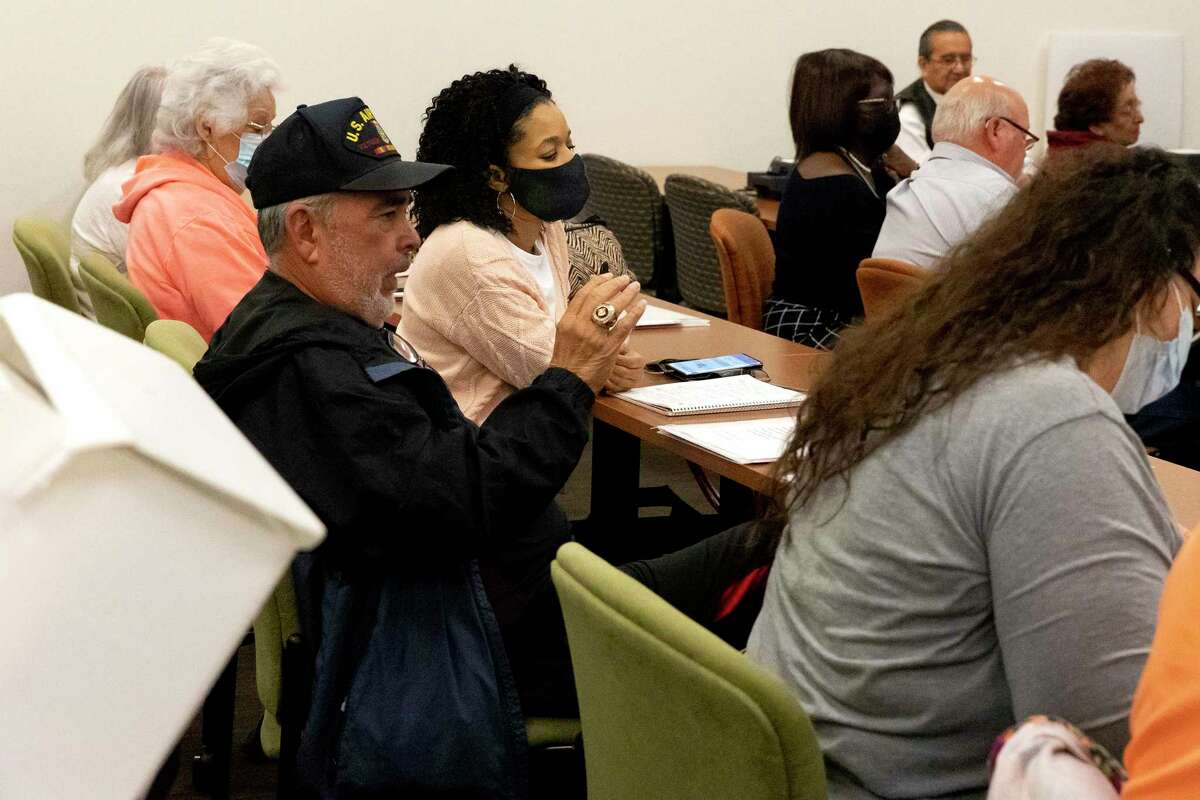 Bobby Canamar, an election judge at the Tobin Library, asks a question about curbside ballots at a training for Bexar County election judges. Early voting begins Oct. 24.