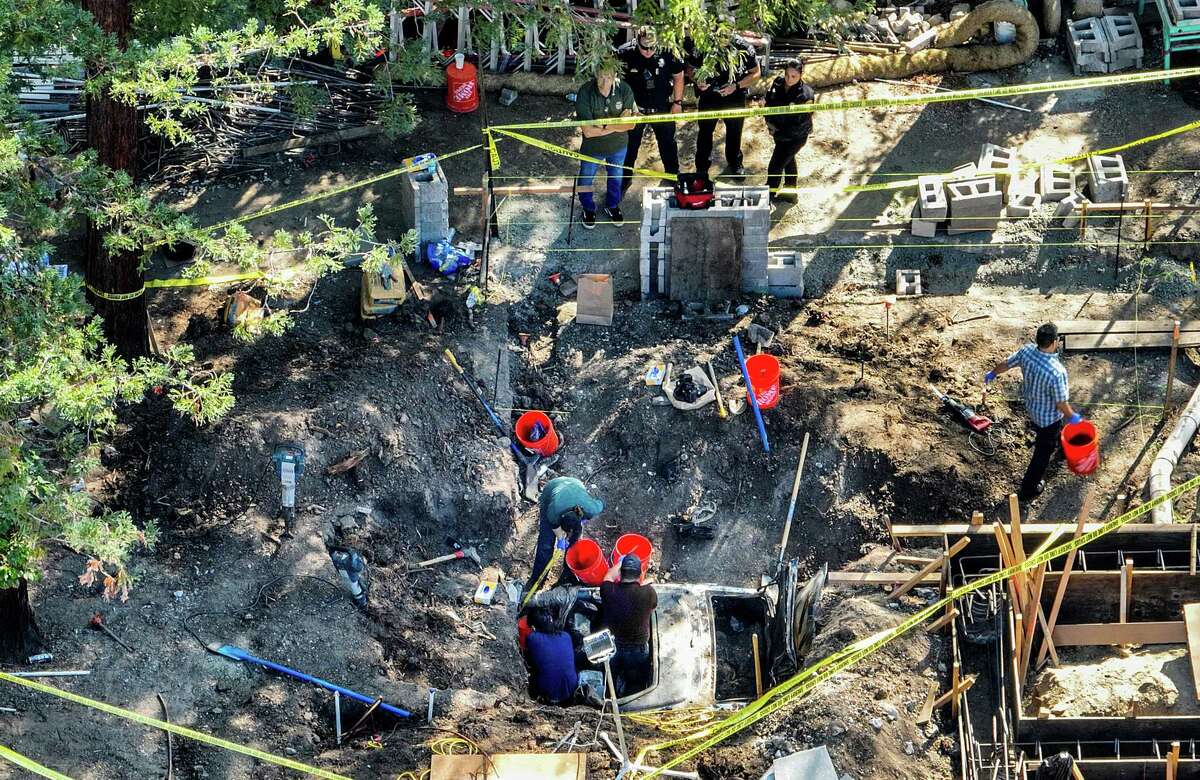Atherton buried car: Police say no human remains recovered. Police officers watch as people search a buried car behind 351 Stockbridge Ave. on Friday, Oct. 21, 2022, in Atherton, Calif.
