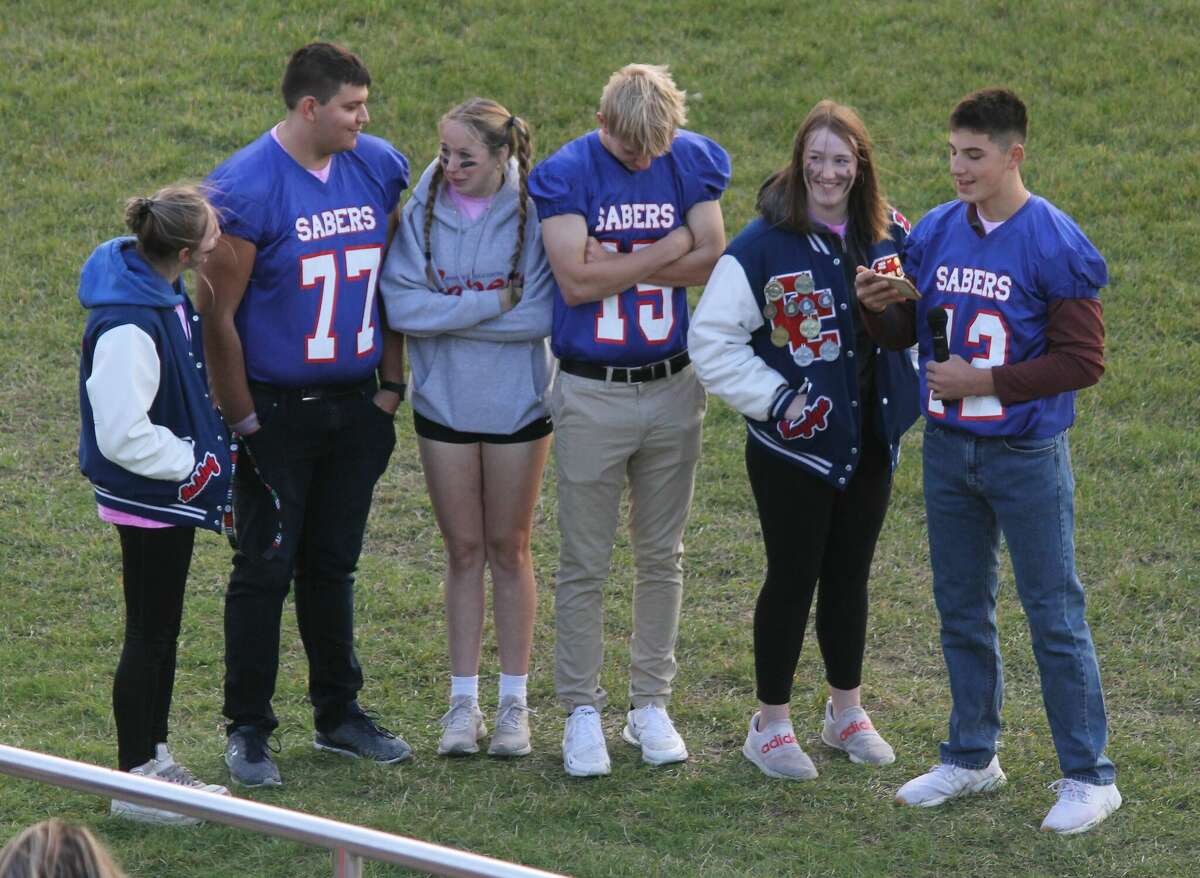 Manistee Catholic Central's homecoming king and queen candidates speak Friday during a pep rally at Saber Stadium.