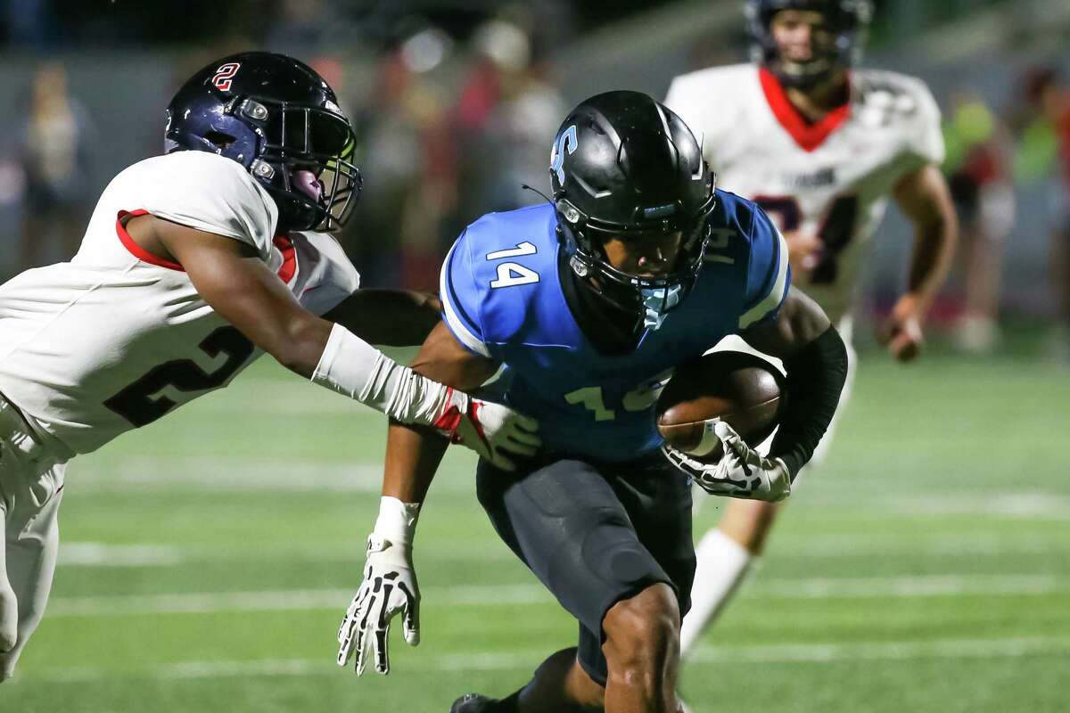 ROSHARON, TX OCT 21: Dawson Eagles Bryson Burgess (2) reaches to tackle Shadow Creek Sharks Joshua Best (14) in the first quarter during the District 23-6A high school football game between the Dawson Eagles and Shadow Creek Sharks at Freedom Field in Rosharon, Texas.
