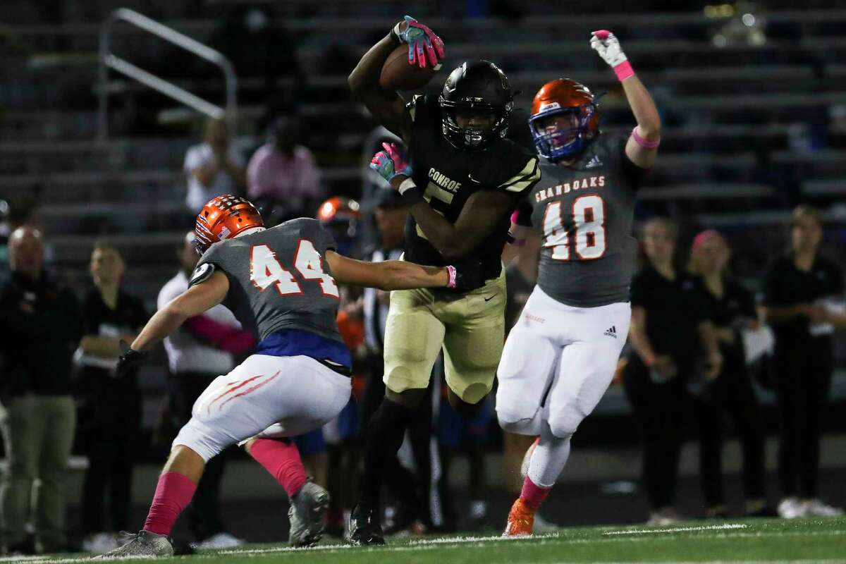 Conroe wide receiver Cameron Thomas (5) runs for a 40-yard gain during the second quarter of a District 13-6A high school football game at Buddy Moorhead Stadium, Friday, Oct. 21, 2022, in Conroe.