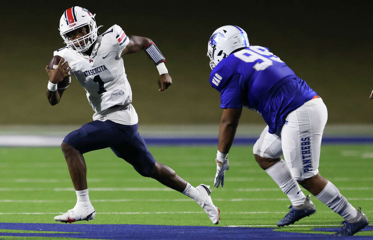 Atascocita Eagles quarter back Zion Brown rushes against the C.,E. King Panther lineman Taumanupepe Samu (99) in the first half of a District 21-6A game football game on October 21, 2022 at Panther Stadium in Houston.