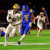 Midland High football player Jalen Brown (right) chases Dow High football player Zack Parker at a rivalry game on Oct. 21, 2022 at the Midland Community Stadium.
