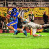 Midland High's Hudson Gerstacker scores a touchdown while Drew Ieuter tries to bring him down during Friday's game against Dow High, Oct. 21, 2022.
