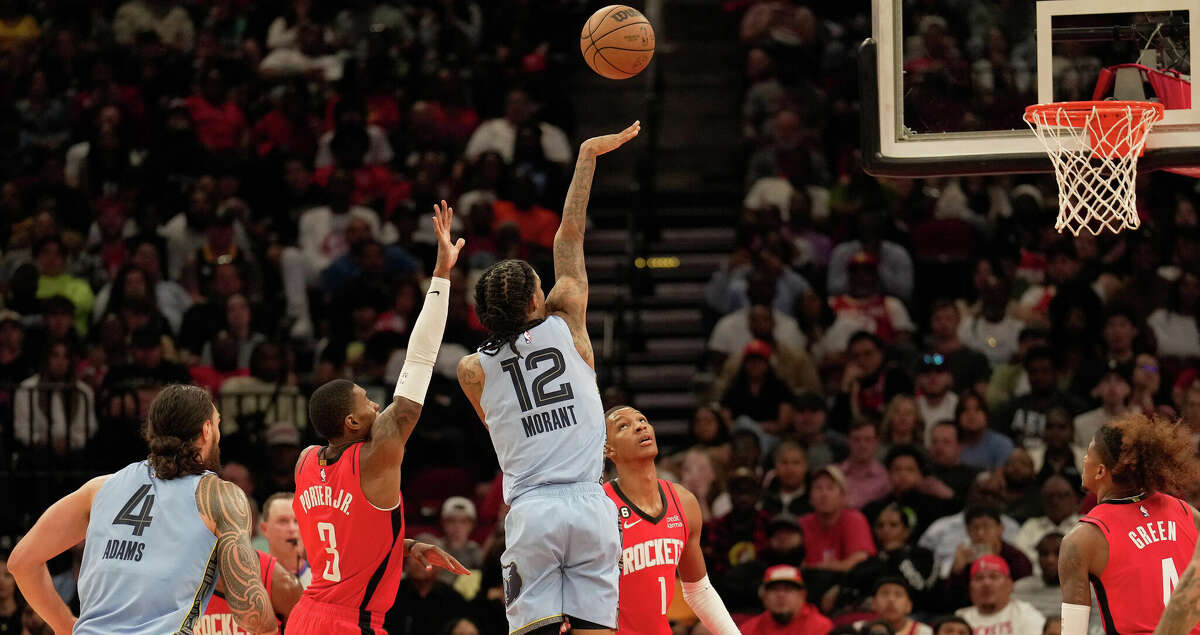Memphis Grizzlies guard Ja Morant (12) takes a shot during the fourth quarter of a NBA game against the Houston Rockets Friday, Oct. 21, 2022, at Toyota Center in Houston. Houston Rockets lost to Memphis Grizzlies 129-122.