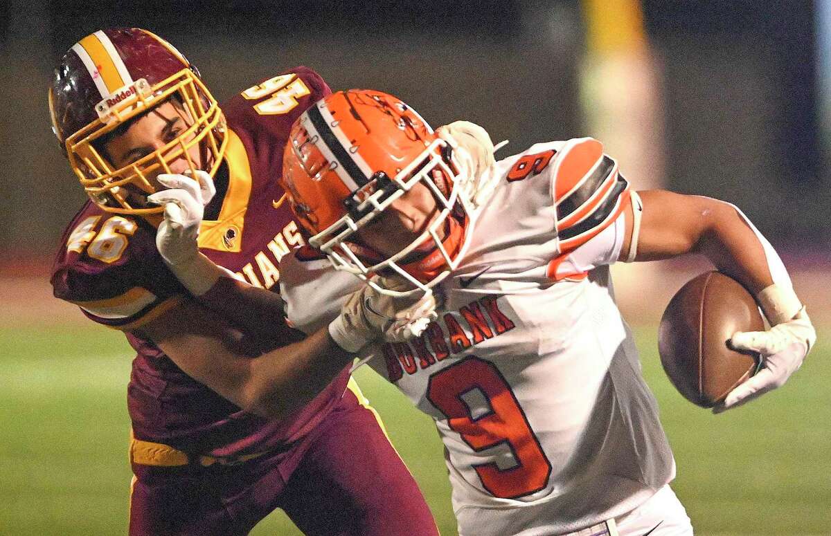 Burbank running back Matthew Cortez (9) is tackled from behind by Harlandale’s Chris Torrez during high school football action a Harlandale Memorial Stadium on Friday, Oct. 21, 2022.