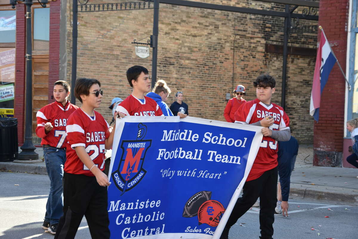 The Manistee Catholic Central Middle School football team walked with banners in the school's homecoming parade on Saturday. 
