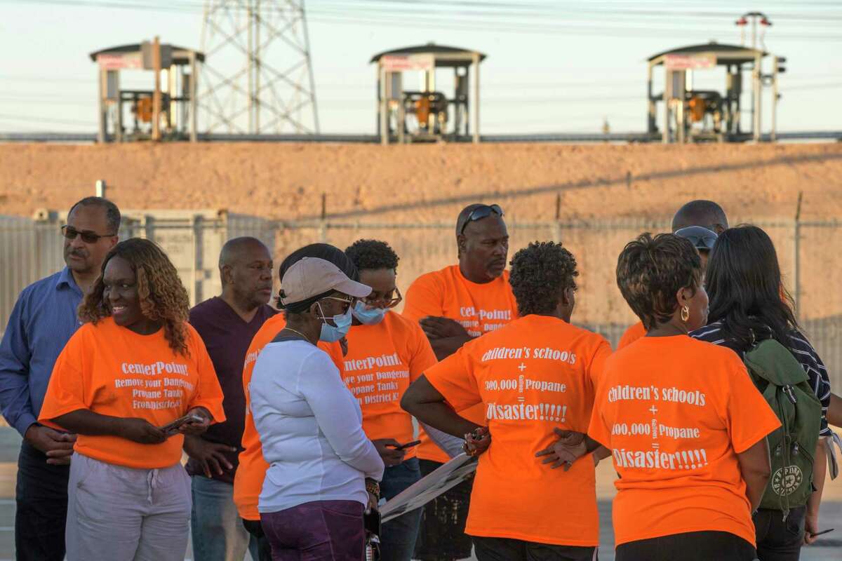 A group of District K residents meet outside Our Savior's Church on Thursday, Oct. 20, 2022, in Houston. The residents' are fighting back against a new CenterPoint propane storage facility seen in the background due to concerns over gas leaks and explosions.