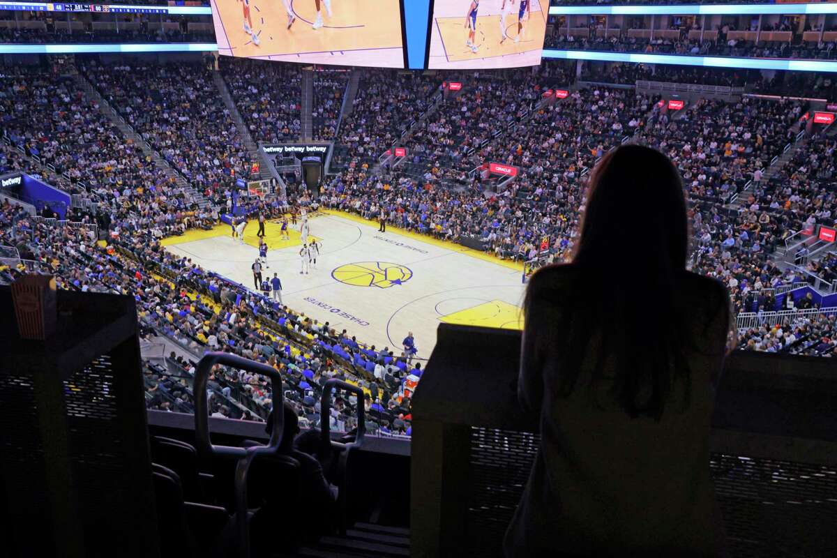 McGuigan watches the Warriors during Friday’s game at Chase Center. She was given a championship ring by the team, presented by Steph Curry, for her years of service.