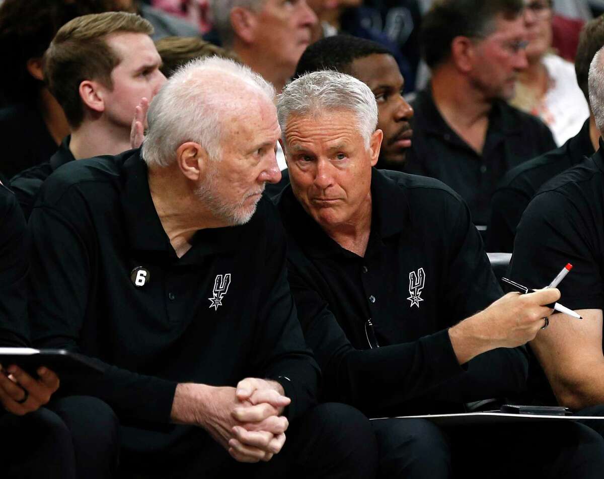 San Antonio Spurs head coach Gregg Popovich talks with assistant coach Brett Brown during game against the New Orleans Pelicans on Sunday, Oct.9,2022.