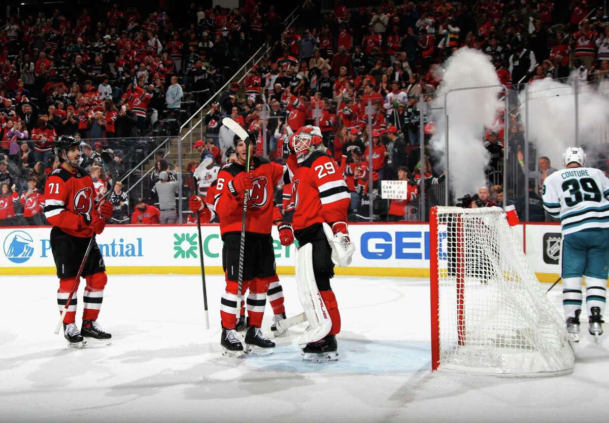 Devils players celebrate after their 2-1 victory over the San Jose Sharks at the Prudential Center Newark, N.J.