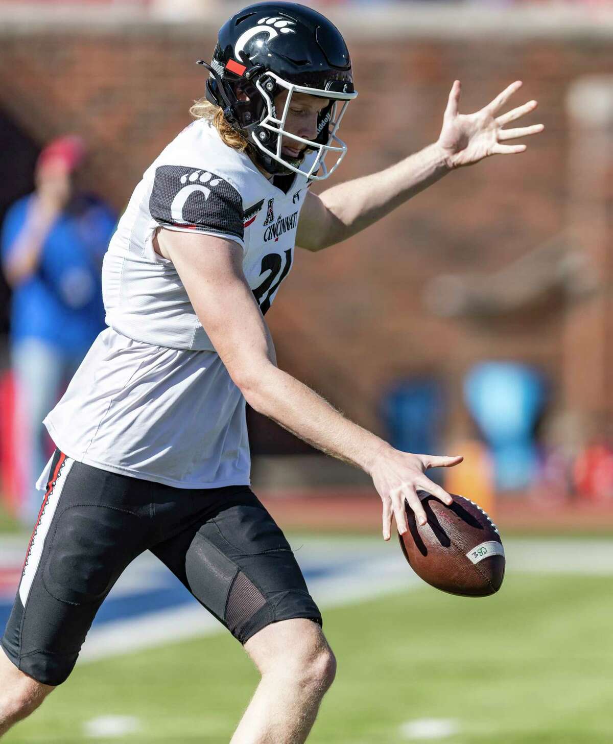 Cincinnati punter Mason Fletcher (31) punts the ball during the first half of an NCAA college football game against against SMU, Saturday, Oct. 22, 2022, in Dallas.