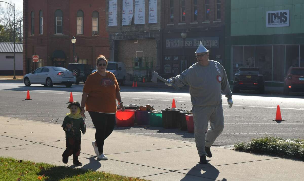 Many families showed up in costume to the Jacksonville Main Street Pumpkin Festival. Jason Parnell (right) arrived as the Tin Man from "The Wizard of Oz," while 2-year-old Maddox Parnell came as the  Scarecrow. 