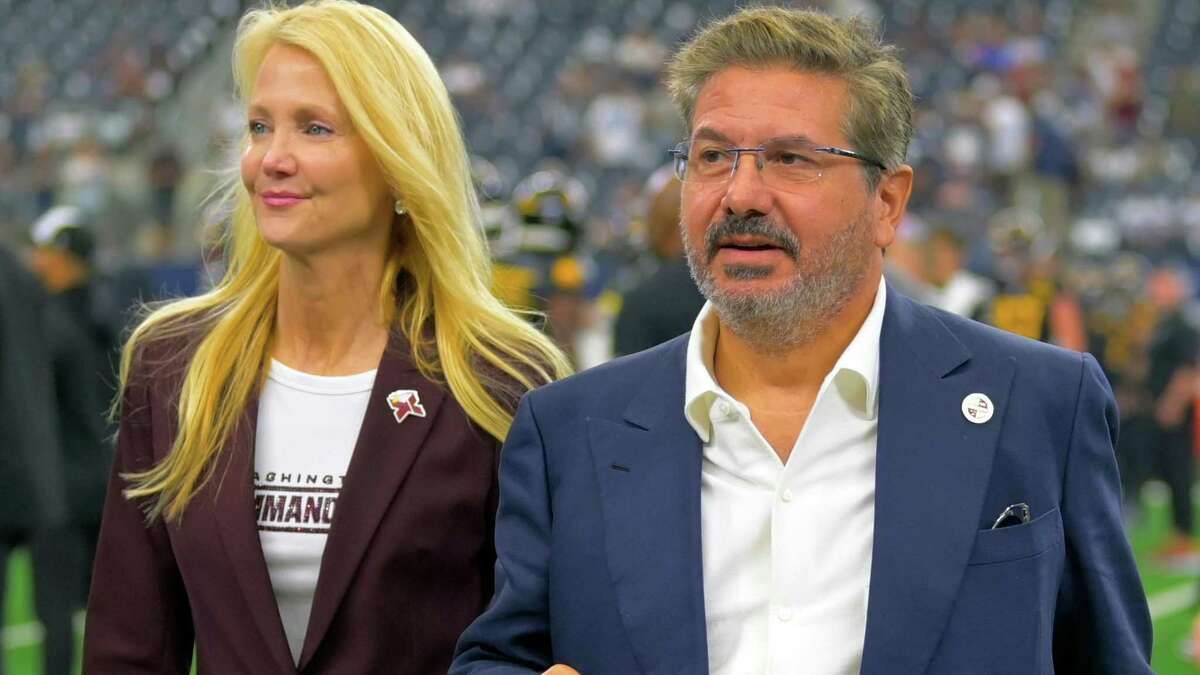 Washington Commanders owners Tanya Snyder and Daniel Snyder on the field before the team's game against the Dallas Cowboys at AT&T Stadium on Oct. 2, 2022, in Arlington, Texas. MUST CREDIT: Washington Post photo by John McDonnell