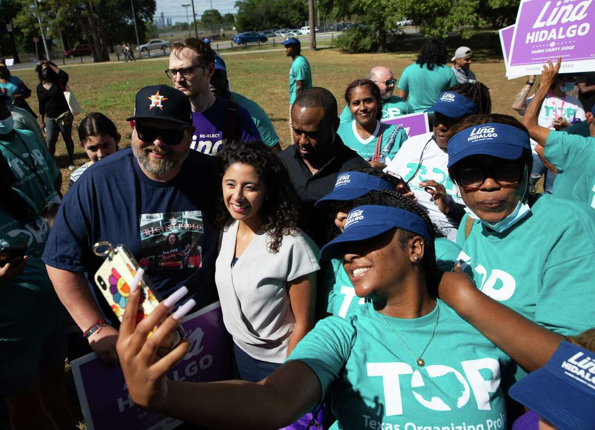 Suppoters take photographs with Harris County Judge Lina Hidalgo after a rally Saturday, Oct. 22, 2022, at Mason Park in Houston. It appears to be part of a tour by the Jane Fonda Climate PAC that Fonda launched in March.