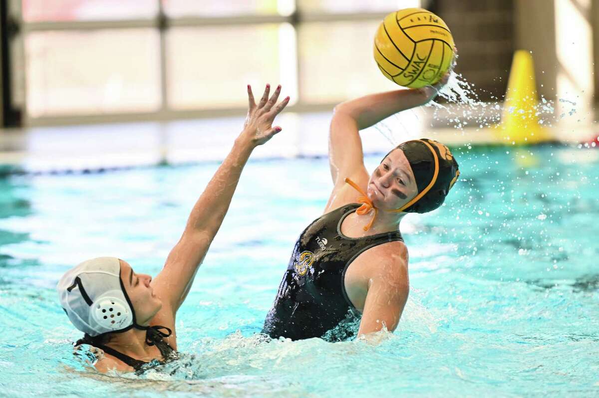 Brennan’s Ally Westendorf shoots a shot on goal during the first period of Saturday’s 6A Region IV water polo regional semi final match against Harlingen South at the Southwest ISD Aquatic Center.