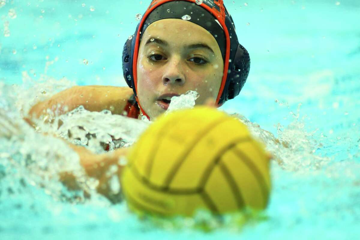 Brandeis’ Sofia Barickman chases down the ball during the first period of Saturday’s 6A Region IV water polo regional semi final match against Harlingen at the Southwest ISD Aquatic Center.