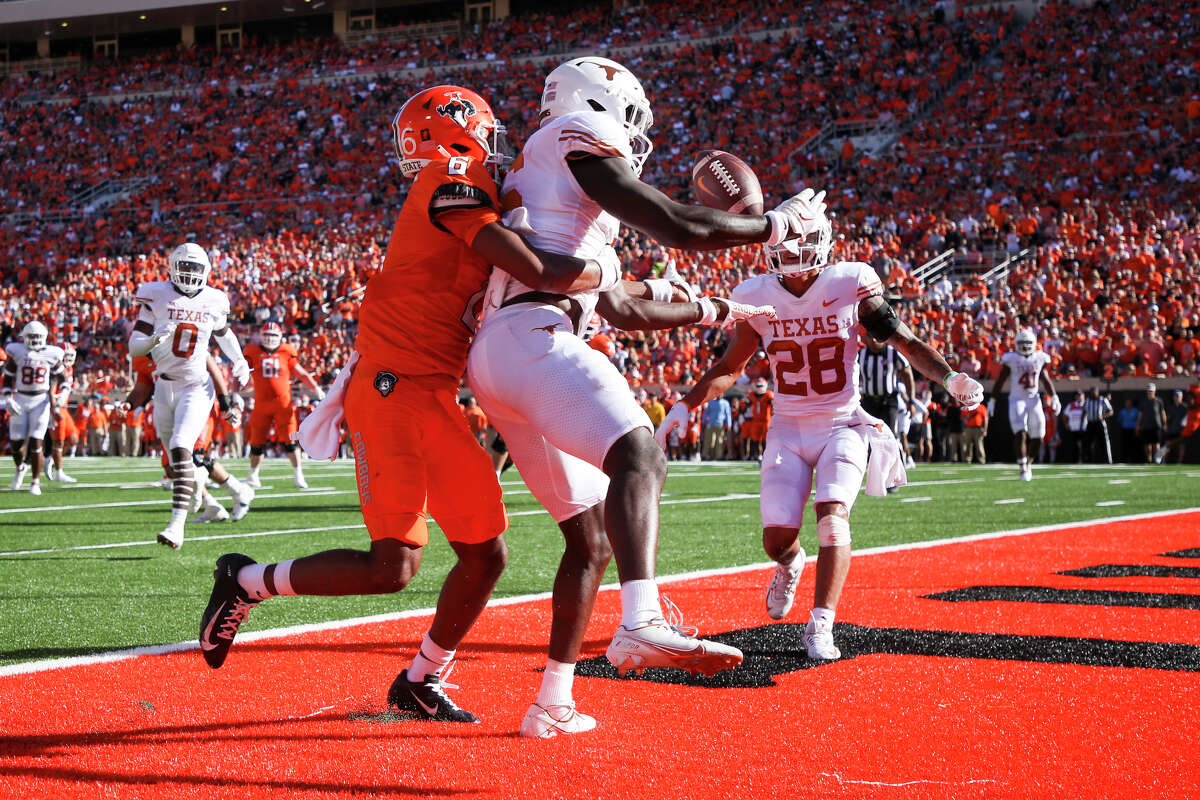 Texas defensive back Ryan Watts (6) intercepts a pass intended for Oklahoma State wide receiver Stephon Johnson Jr. (6) in the end zone during the second quarter of an NCAA college football game in Stillwater, Okla, Saturday, Oct. 22, 2022. (Ian Maule/Tulsa World via AP)