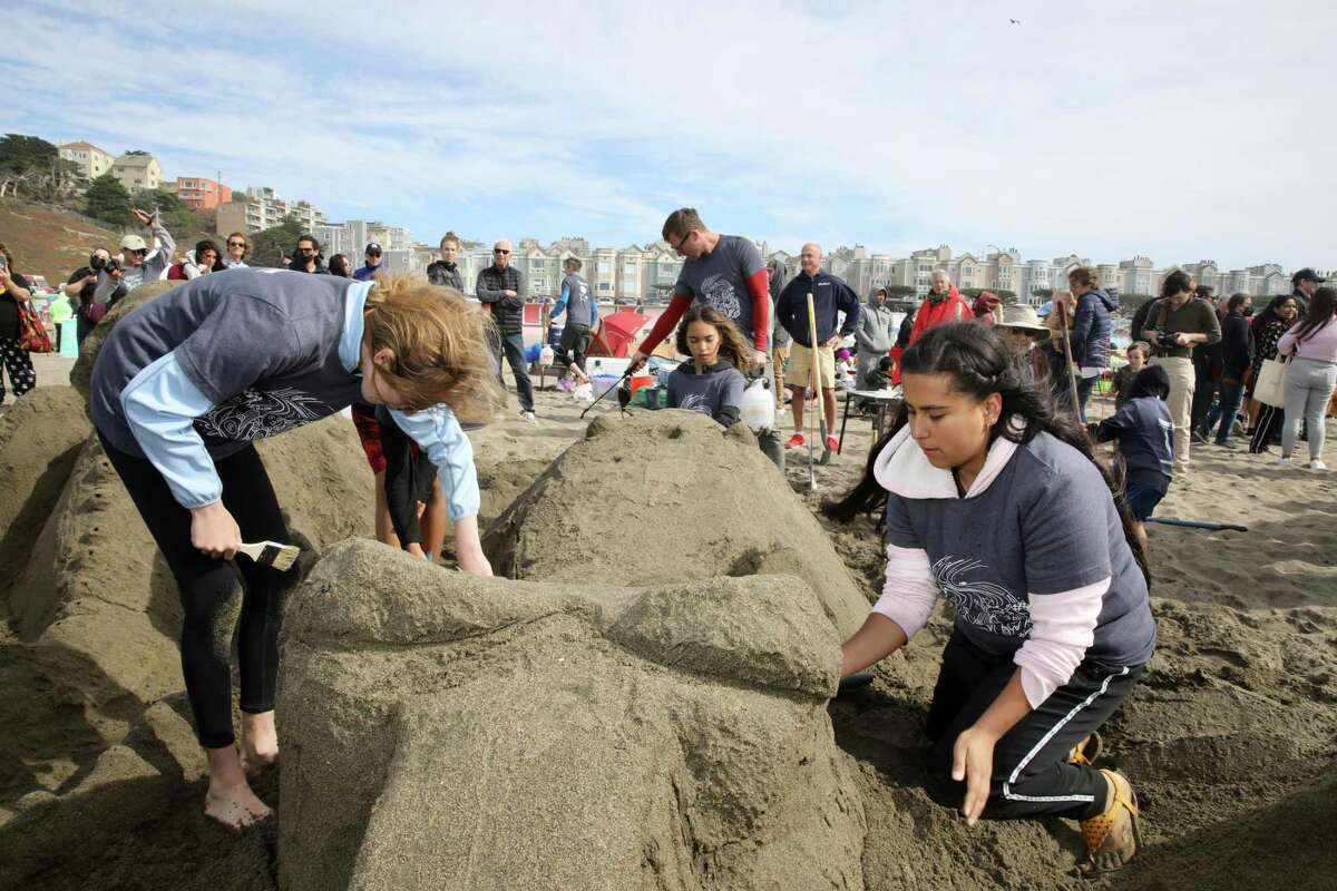 Katy Vergara, 14, sculpts a whale with Team Shore Thing during the sandcastle contest.