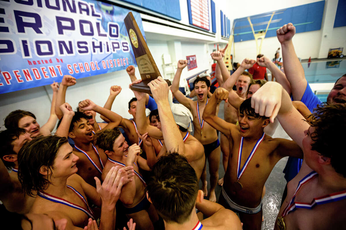 UIL regional champions Brazoswood players celebrate with the trophy during the high school water polo, Region II finals at Lamar High School in Houston, TX, October 22, 2022. Brazoswood defeated Dawson 15-13.