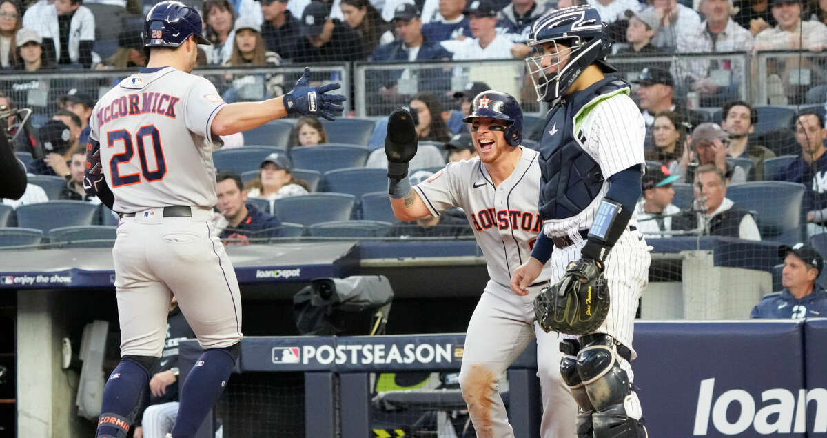 Houston Astros Christian Vazquez, center, celebrates with Chas McCormick after McCormick's 2-run home run against New York Yankees starting pitcher Gerrit Cole to give the Astros a 2-0 lead in the second inning during Game 3 of the American League Championship Series at Yankee Stadium on Saturday, Oct. 22, 2022, in New York.
