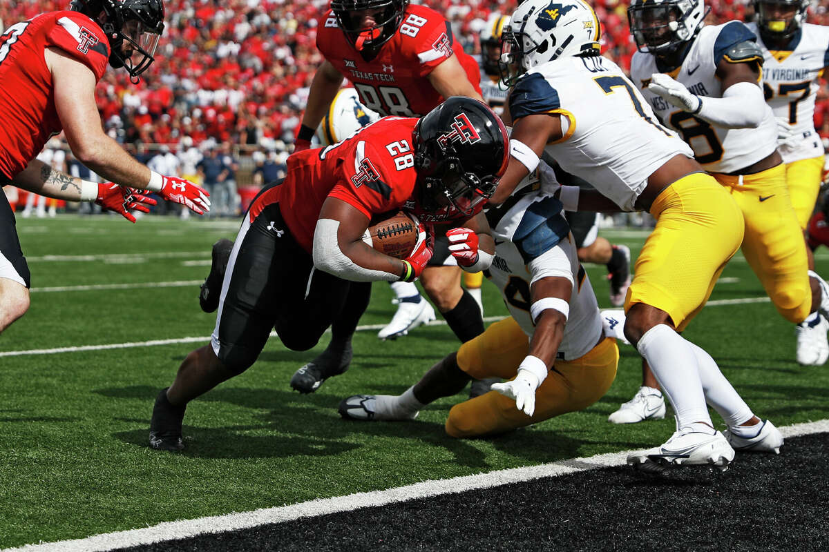 Texas Tech's Tahj Brooks (28) scores a touchdown during the first half of a college football game against West Virginia, Saturday, Oct. 22, 2022, in Lubbock. (AP Photo/Brad Tollefson)