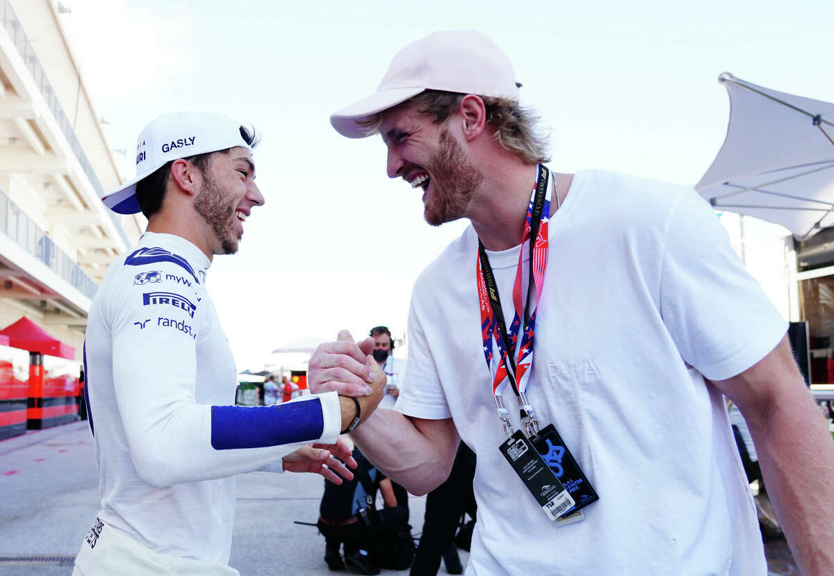 AUSTIN, TEXAS - OCTOBER 24: Pierre Gasly of France and Scuderia AlphaTauri meet Logan Paul in the paddock ahead of the F1 Grand Prix of the United States at Circuit of the Americas on October 24, 2021 in Austin, Texas.  (Photo by Alex Bierens de Haan - Formula 1/Formula 1 via Getty Images)