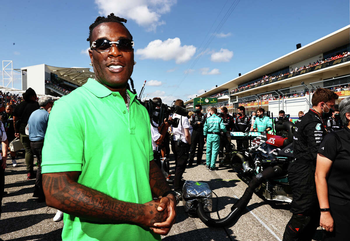 AUSTIN, TEXAS - OCTOBER 24: Burna Boy poses for a photo on the grid during the United States F1 Grand Prix at Circuit of the Americas on October 24, 2021 in Austin, Texas.  (Photo by Mark Thompson/Getty Images)