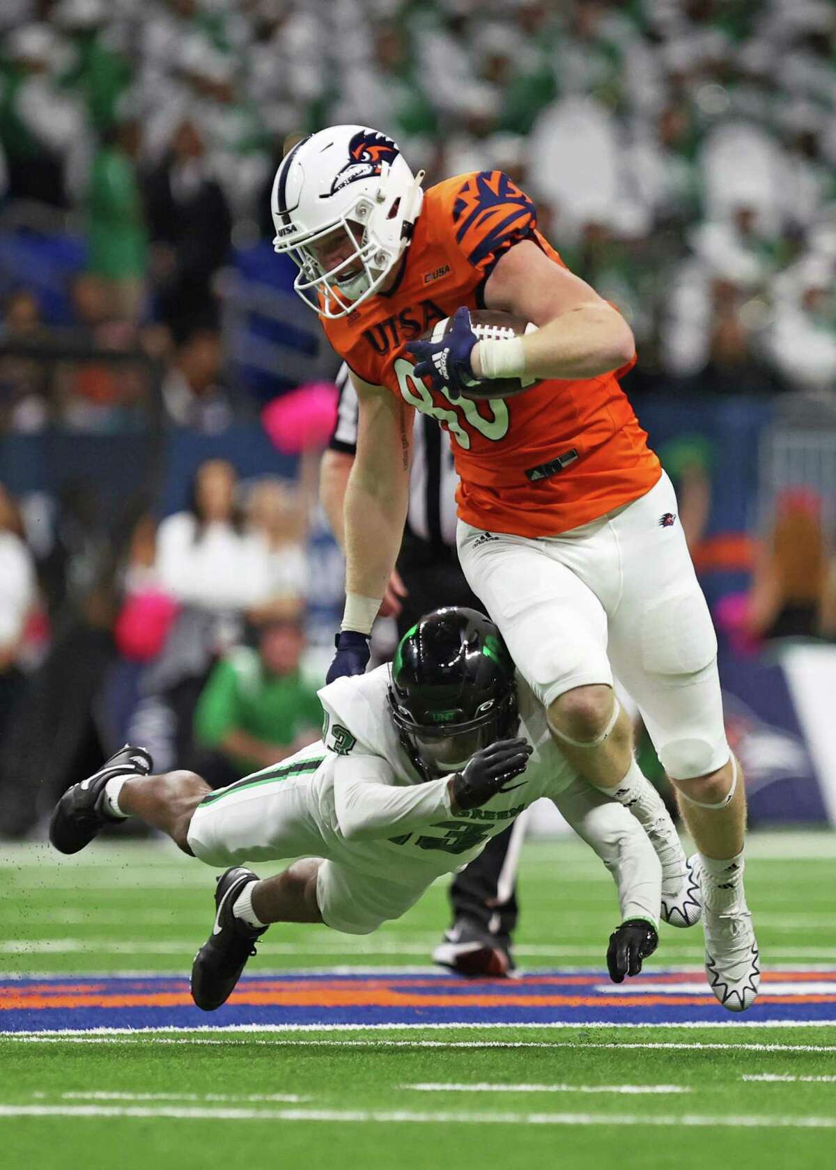 UTSA tight end Dan Dishman (80) is tackled during the NCAA Conference USA football game against North Texas Saturday, Oct. 22, 2022, at the Alamodome in San Antonio, Texas.