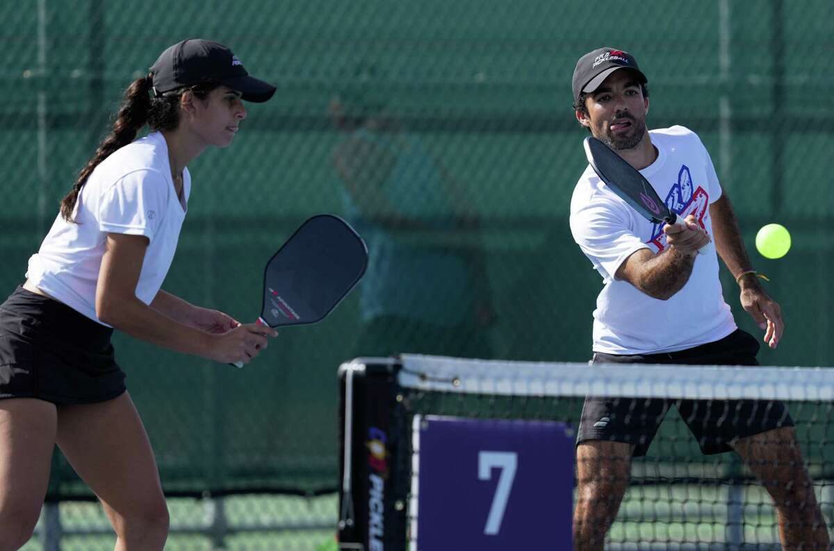 Alejandra Lopez and Eduardo Irizarry play in a professional double match at the Association of Pickleball Professional Sunmed Houston Open tournament Sunday, Oct. 23, 2022, at Memorial Park Tennis Courts in Houston. It was the first time a national pickleball event of this kind has come to Houston.