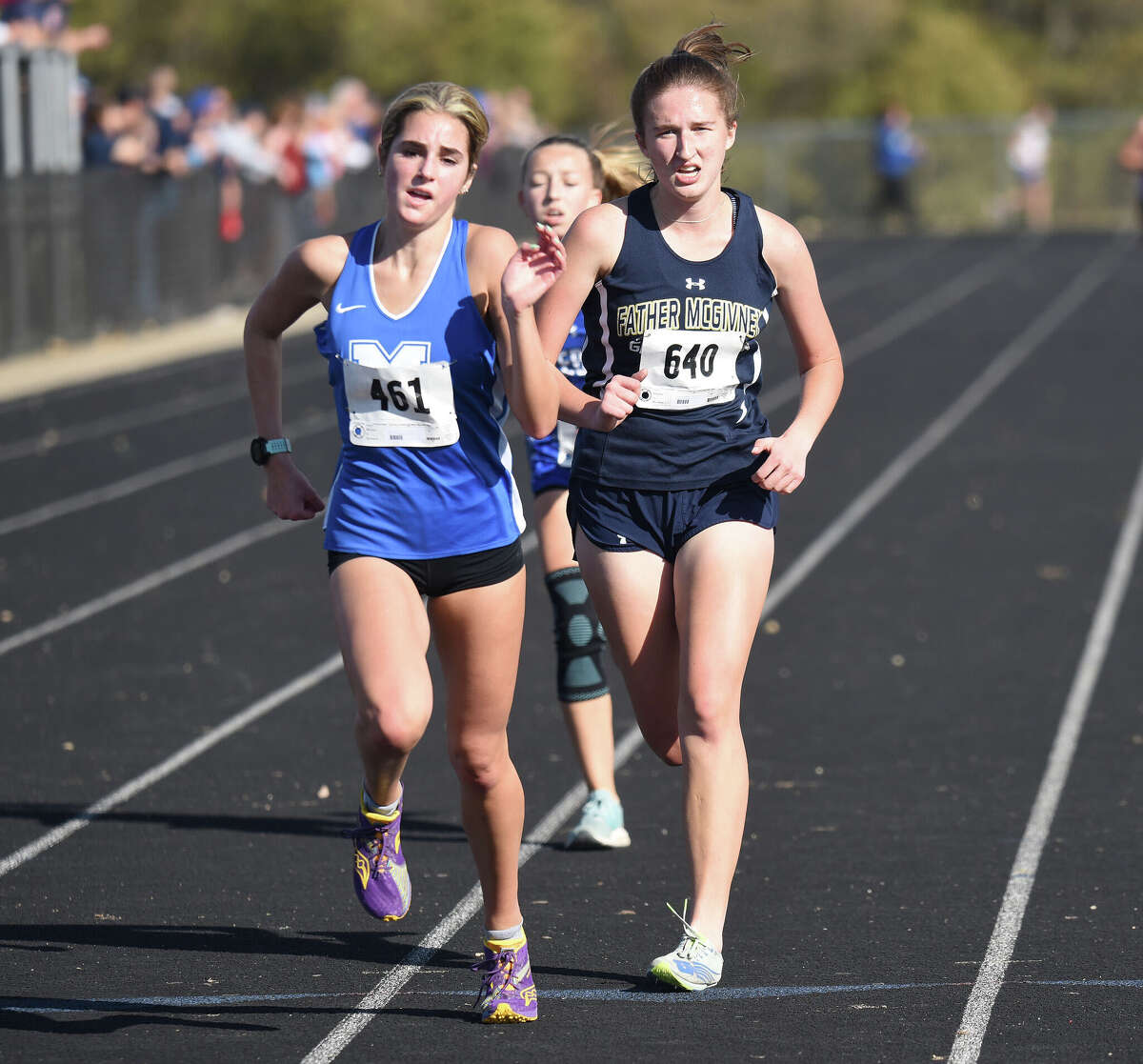 Marquette Catholic's Kailey Vickrey (left) and Father McGivney's Alyssa Terhaar push to the finish line at the Wesclin Class 1A Regional in Trenton.