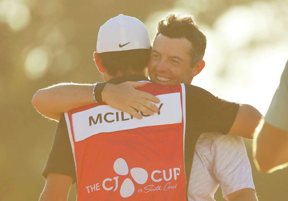 Rory McIlroy celebrates with his caddie Harry Diamond after his win.
